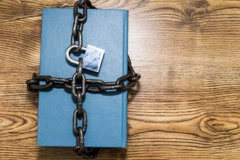 Information security concept, book with chain and padlock. Stock Photos