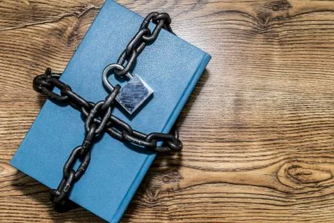 Information security concept, book with chain and padlock. Stock Photos