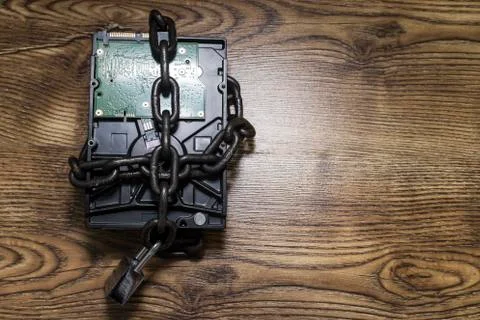 Information security concept, hard disk with chain and padlock. Stock Photos