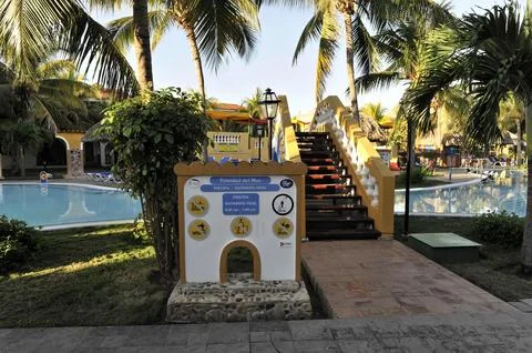 Information stand with pool rules and signs next to a resort swimming pool Stock Photos