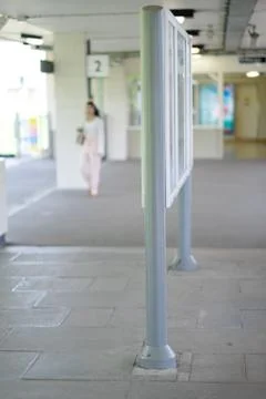 Information stand with a train schedule on the platform of the railway statio Stock Photos