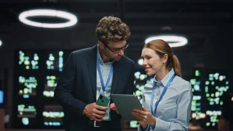 Information technology specialists working tablet at night datacenter closeup 写真素材