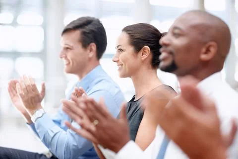 Informative seminar. Team of happy colleagues applaud while in a business Stock Photos