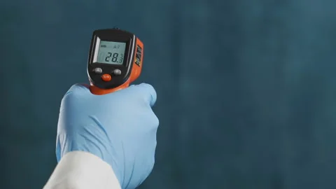 Infrared laser thermometer in hand Stock Footage 103246143