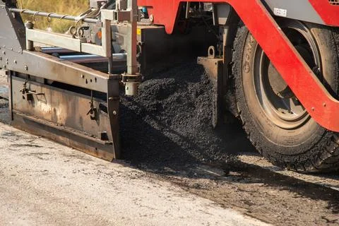 Infrastructure development asphalt paving and urban roadwork close-up at co.. Stock Photos