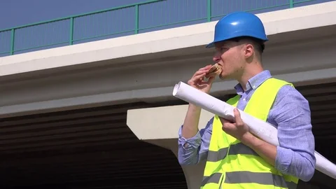 Infrastructure development city bridge construction engineer eating lunch food Stock Footage
