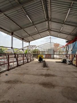 Infrastructure project at railway station featuring unfinished bridge and w.. Stock Photos