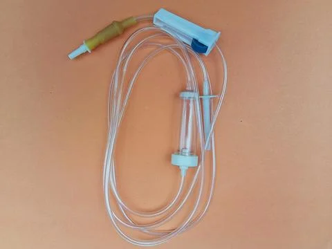 Infusion set on warm background Stock Photos