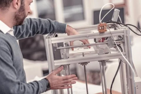 Ingenious designer working with 3D printer in design studio Foto stock