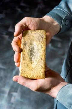 Ingot in hands Stock Photos