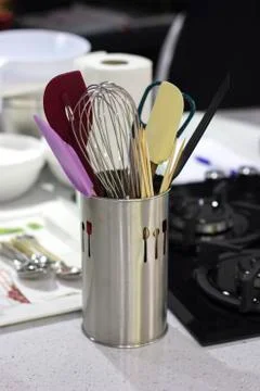 Ingredients and cooking utensils on a table in a metal cup. Stock Photos