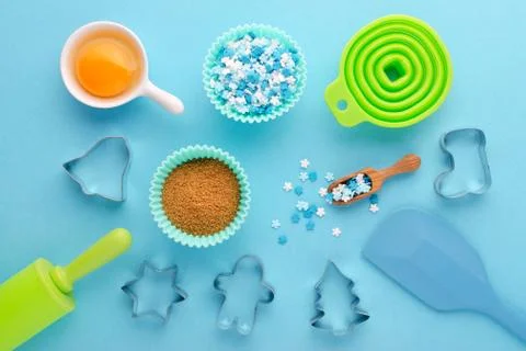 Ingredients and kitchen tools for baking with cookies cutter on blue background Stock Photos