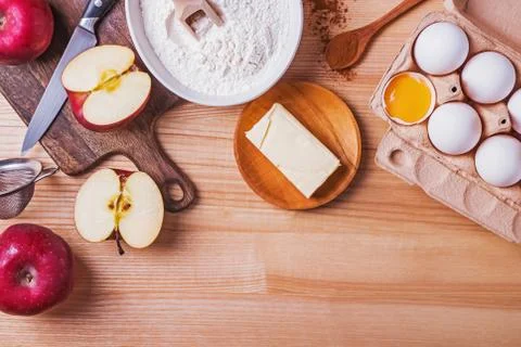 Ingredients and tools for apple pie on the wooden table, top view. Stock Photos