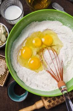 Ingredients and tools to make a cake - flour, butter, milk, eggs, honey Stock Photos