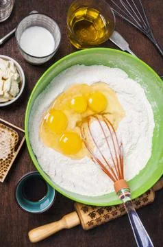 Ingredients and tools to make a cake - flour, butter, milk, eggs, honey, olive Stock Photos