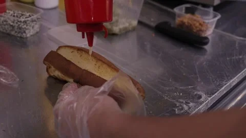Ingredients are on the table. Mustard is being drizzled on top in slow motion. Stock Footage 251726438