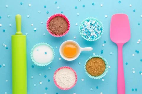 Ingredients for baking and kitchen tools on blue background, flat lay Stock Photos