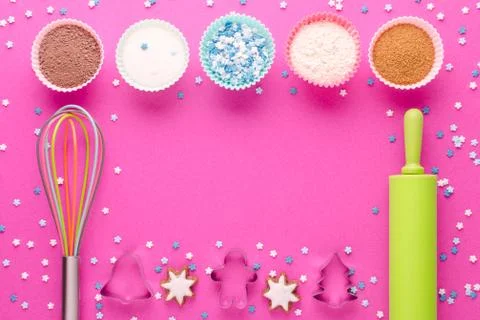 Ingredients for baking and kitchen tools with cookie cutter on pink background Stock Photos