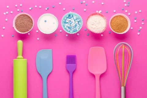 Ingredients for baking and kitchen tools on pink background, flat lay Stock Photos