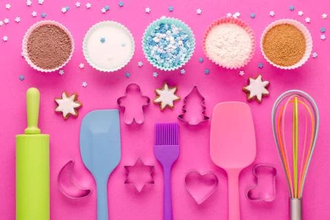 Ingredients for baking and kitchen tools with cookie cutter on pink background Stock Photos