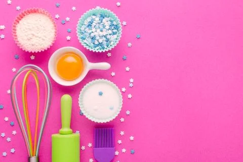 Ingredients for baking and kitchen tools on pink background with copy space Stock Photos