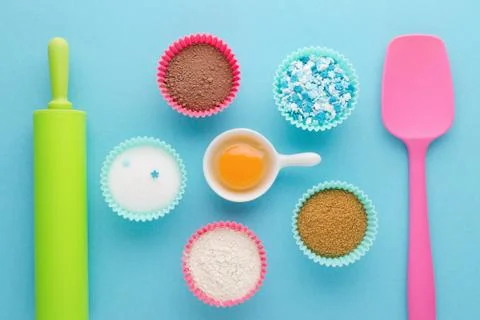 Ingredients for baking and kitchen tools on blue background, flat lay Stock Photos