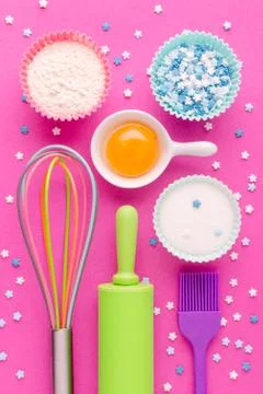 Ingredients for baking and kitchen tools on pink background Stock Photos