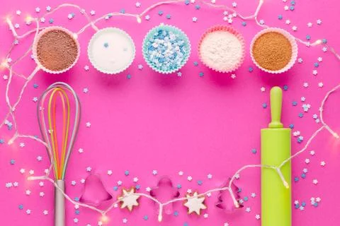 Ingredients for baking and kitchen tools with cookie cutter on pink background Stock Photos