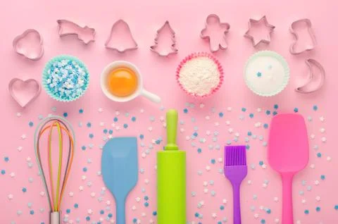Ingredients for baking and kitchen tools with cookie cutter on pink background Stock Photos