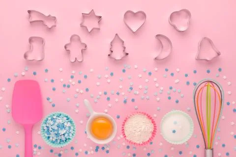 Ingredients for baking and kitchen tools with cookie cutter on pink background Stock Photos