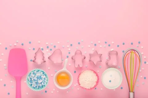 Ingredients for baking and kitchen tools with cookie cutter on pink background Stock Photos
