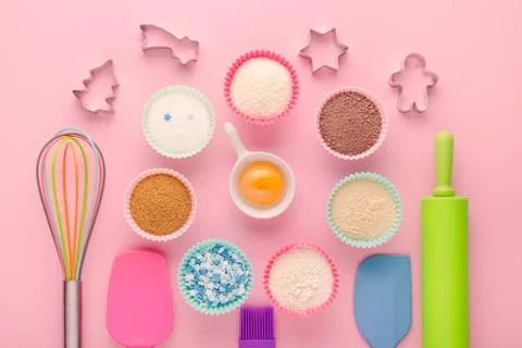 Ingredients for baking and kitchen tools with cookie cutter on pink background Stock Photos