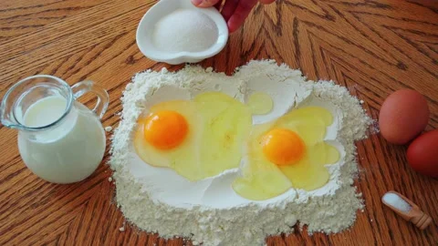 Ingredients for baking are put on the table by a beautiful Caucasian female hand Stock Footage 172546842