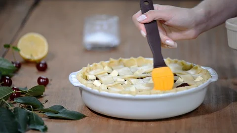 Ingredients for baking cake stuffed with fresh cherry pie. Female preparing Stock Footage 92138849