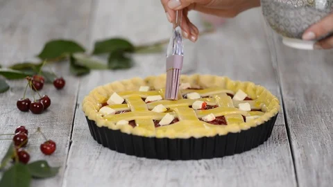 Ingredients for baking cake stuffed with fresh cherry pie. Female preparing Stock Footage 112221429