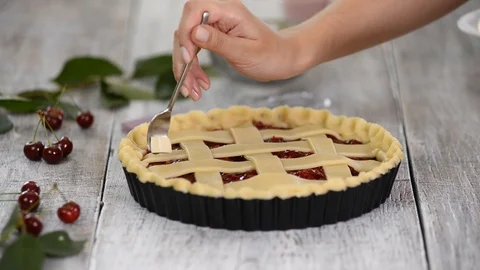 Ingredients for baking cake stuffed with fresh cherry pie. Female preparing Stock Footage 113571485