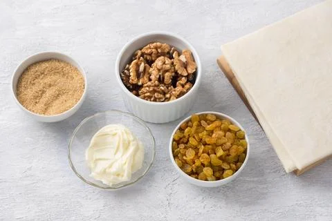 Ingredients for baking Easter cake kraffin: puff pastry, raisins, walnuts Stock Photos