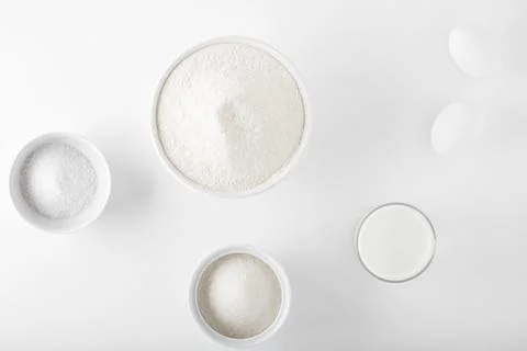 Ingredients for baking on a white table in white dishes Stock Photos