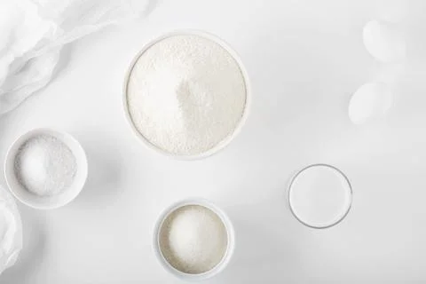 Ingredients for baking on a white table in white dishes Stock Photos