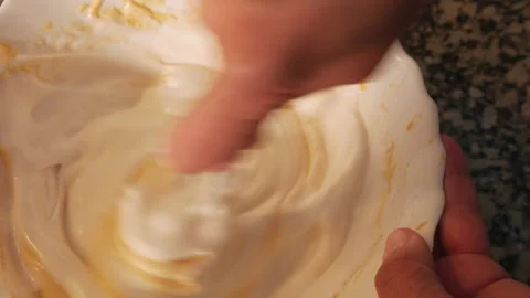 Ingredients of a cake being mixed with a spoon Stock Footage 152578922