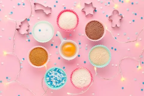 Ingredients like a clock, baking time concept, on pink background with garland Stock Photos