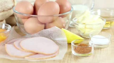 Ingredients for eggs Benedict (eggs, ham, English muffins) Stock Footage 24671550