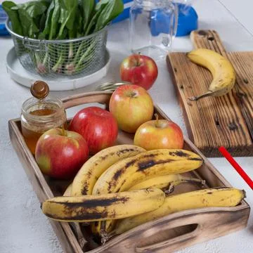 Ingredients of fruit smoothie with spinach on table Photos