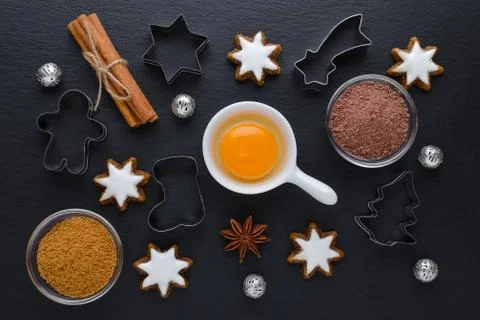 Ingredients with kitchen tools for dessert baking and star cookies on black Stock Photos