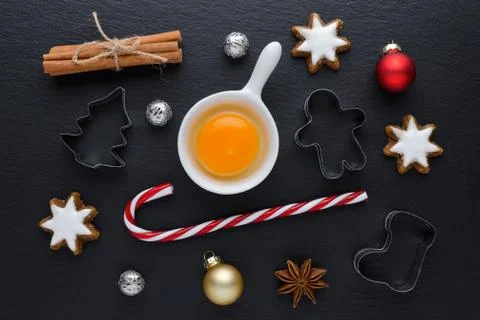 Ingredients with kitchen tools for dessert baking and star cookies on black Foto stock