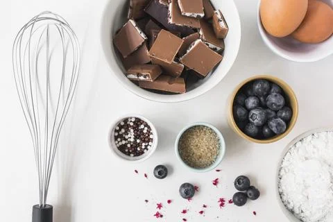 Ingredients making cake with whisk white background Stock Photos