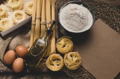 Ingredients for making pasta on a wooden background. Stock Photos