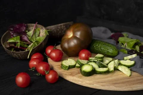 Ingredients for making salad on rustic black board background. Vegetable salad Stock Photos