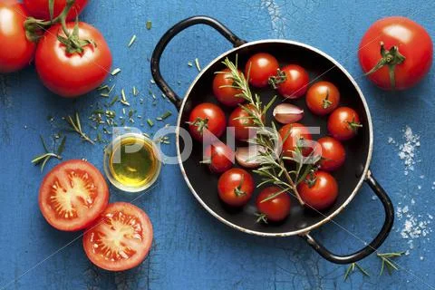 Ingredients For Pasta Sauce: Cherry Tomatoes, Rosemary, Garlic And Olive Oil