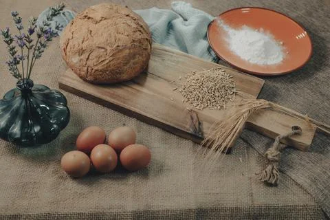 Ingredients for the preparation of the bread on a rustic tablecloth. Stock Photos